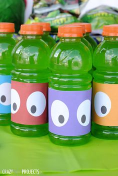 some green water bottles with eyes on them