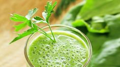 a green smoothie in a glass on a table