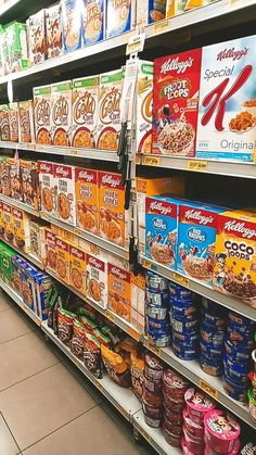 an aisle in a grocery store filled with cereals and other foods on display for sale