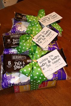 some candy wrapped in green and white polka dots with tags attached to them on a wooden table