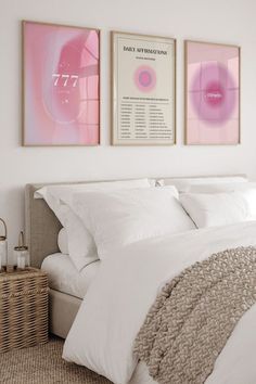 a bedroom with two paintings above the bed