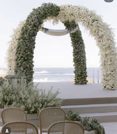 an outdoor ceremony setup with chairs and flowers