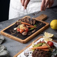 a person cutting up food on top of a wooden plate with a knife and fork