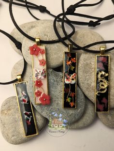 Designed with a nod to Japanese culture, these artisan necklaces are a tribute to the stunning landscapes and rich mythology of Japan. Though they might seem like the perfect accessory for 'the lads,' they are, in truth, crafted for anyone who appreciates beauty and artistry.  Made of resin, every detail in these necklaces has been meticulously handcrafted and thoughtfully assembled to capture the essence of Japanese aesthetics. Japanese Necklace Traditional, Hand Painted Resin Jewelry For Gifts, Red Artistic Design Jewelry For Gift, Black Jewelry With Artistic Design As Gift, Artistic Red Necklace For Gift, Rectangular Resin Jewelry Gift, Decorative Spiritual Necklaces For Gifts, Spiritual Decorative Necklaces For Gifts, Artistic Resin Pendant Necklace