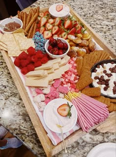 a tray full of snacks and desserts on a table