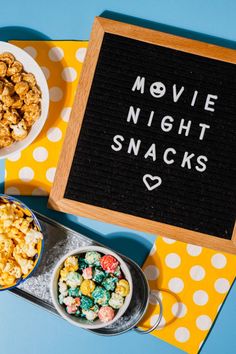 the movie night snacks are ready to be eaten on the table with popcorn in bowls