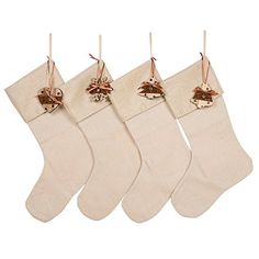 three christmas stockings with bells hanging from them