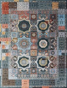 an old patchwork rug with many different colors and designs on it's sides