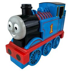 a thomas the tank engine toy is shown on a white background and looks like he's smiling