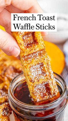 french toast waffle sticks being dipped with sugar