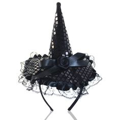 a black hat with lace and bows on it's side, sitting in front of a white background