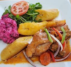 a white plate topped with meat and veggies