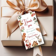 a gift wrapped in brown ribbon with a thank you card attached to the top of it