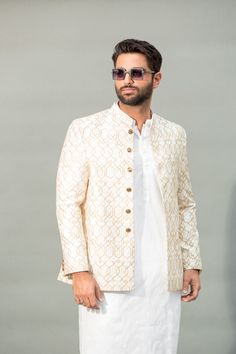 Welcome to Shiraz Saeed Our Retail Store: Rubina's Collection 2070 W Spring creek Pkwy Suite 328 Plano,TX USA 75023 Presenting Men's Off-White Embroidered Jamawar Prince Coat (Kindly provide your size upon checkout) Color: Off-White Premium Embroidered Jamawar Banarsi Fabric Italian Thread Simple & Decent Metal Buttons Finest Stitch Branded Design Custom Sizes are also available. Fit Type: Regular fit Wash Care Instructions: Dry Clean Only Suitable For India Wedding, Festivals And Social Gatherings Disclaimer Due to the photographic lighting & different screen calibrations, the colors of the original product may slightly vary from the picture. Embroidered Cream Nehru Jacket For Wedding, White Nehru Jacket For Wedding Festivities, White Nehru Jacket With Zari Work For Groom, White Nehru Jacket With Resham Embroidery For Wedding, Embroidered Cream Bandhgala For Groom, Classic Cream Nehru Jacket For Wedding, Designer Embroidered Outerwear For Wedding, White Traditional Wear With Resham Embroidery For Groom, Designer Wedding Outerwear With Intricate Embroidery