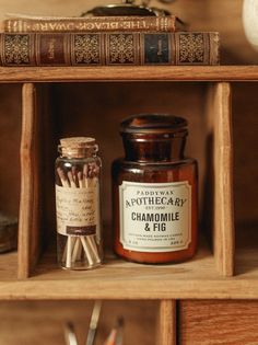 an open book shelf filled with lots of books next to a jar of cinnamon sticks