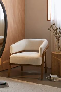 a white chair sitting in front of a mirror