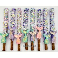 six mermaid themed candy sticks are lined up in a row on top of each other