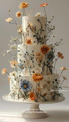 a three tiered cake with flowers on it