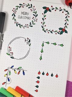 a sheet of paper with christmas doodles on it and markers next to the pages