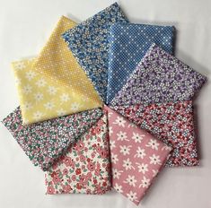 six different colors of fabric with flowers on them, all in various sizes and shapes