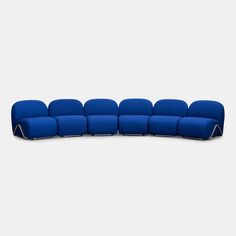 a blue couch sitting on top of a white floor