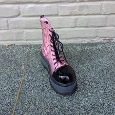 The Demonia Slacker-88 Ankle Boot In Pink Has A Black Spiderweb Detail, As Well As A 2" Platform And Front Lacing Closure. #Demonia #Demoniaslacker88 #Slacker88 Punk Style High-top Synthetic Boots, Alternative High-top Synthetic Boots, Trendy Closed Toe Platform Boots For Streetwear, Punk Low-top Boots For Streetwear, Punk Low-top Streetwear Boots, Edgy Low-top Platform Boots, Edgy Synthetic Combat Boots For Streetwear, Synthetic Round Toe Combat Boots For Streetwear, Pink Chunky Platform Sneakers For Streetwear