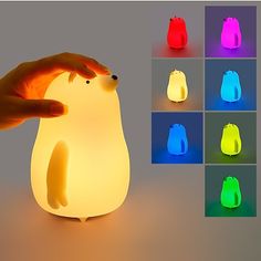 a person holding a lit up penguin lamp in front of several different color options to choose from