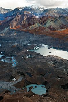 an aerial view of mountains and lakes in the desert