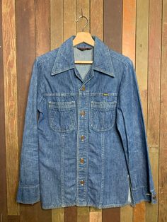 "Vintages 1970s Made In USA Wrapid Transit From Wrangler Denim Shirt  Great cut, cool stitching for the perfect 70s vibe!  Near mint condition, a little wear and discolouration on left elbow.  Pit to pit - 18\"  Top to bottom - 28\"   Shoulder to cuff - 25\"" Vintage Cotton Shirt For Rodeo, Vintage Medium Wash Pre-washed Tops, Vintage Denim Top For Rodeo, Vintage Medium Wash Tops For Rodeo, Retro Medium Wash Top For Fall, Vintage Button-up Shirt For Rodeo, Vintage Medium Wash Top With Button Closure, Fitted Vintage Pre-washed Tops, Vintage Fitted Pre-washed Tops