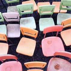 many different colored chairs sitting next to each other