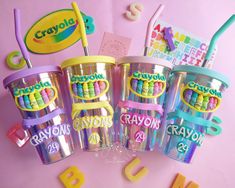 the crayon cups are all lined up with their names and numbers on them