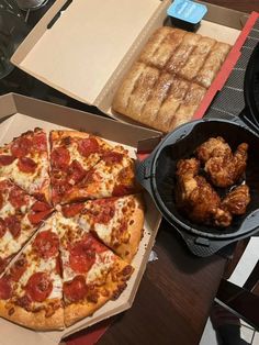 pizza and chicken wings are sitting on the table