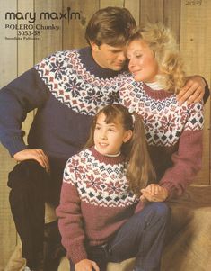 a man and woman in matching sweaters sitting next to each other