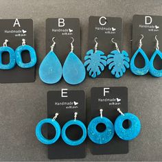 six pairs of earrings with different shapes and colors are shown in front of each other