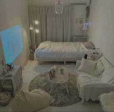 a bedroom with white furniture and lights on the ceiling, in front of a flat screen tv