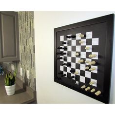 a black and white chess board mounted to the wall