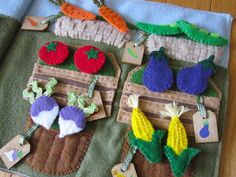 an open book with felt fruits and vegetables on it