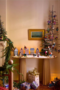 a christmas tree is next to a table with presents on it