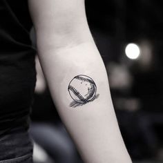 a woman's arm with a baseball tattoo on the left side of her arm