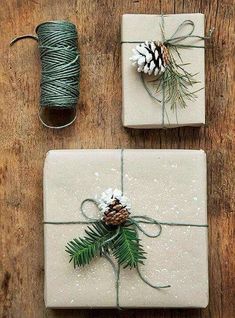 presents wrapped in white paper with pine cones and twine