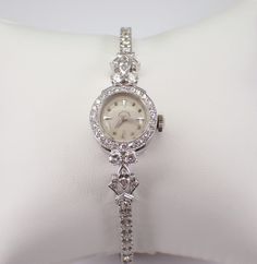 "Vintage Antique Art Deco HAMILTON Watch, dating back to the 1920's. Hand wound Mechanical movement in perfect working condition with a power reserve of approximately 30 hours per wind. The watch is crafted in a 14 Karat White Gold. Both the watch case and the bracelet are white gold and set with genuine Round Diamonds. There are sixty-one genuine round diamonds and two Marquise Diamonds set in the watch case the bracelet band. These diamonds are G in color, SI/VS in clarity and combine to a total weight of 2 1/4 carats. The watch weighs 16.4 grams and measures 6\" in length. This watch will ship promptly in a gift box (not original box), accompanied by an appraisal, valued at $6,495.00. ADDITIONAL REQUESTS If you would like to see more pictures of this item, please let us know and we woul Luxury Wedding Jewelry And Watches With Bracelet Strap, Luxury Timeless Diamond White Watch, Luxury Victorian Style Watch, Luxury Vintage Diamond Watch With Subdials, Luxury Victorian Style Watch With Round Dial, Luxury Vintage Silver Watch Accessories, Luxury Antique Formal Watch Accessories, Luxury Vintage Rectangular Watch Accessories, Platinum Wedding Watch, Round