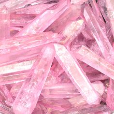 pink crystals are in a bowl on the table