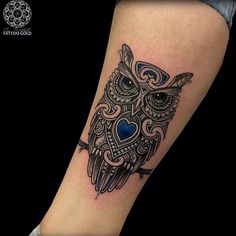 an owl tattoo on the arm