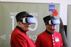 two men in red uniforms with google glasses on their heads are standing next to each other