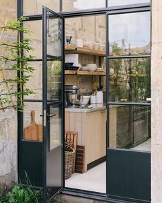 an open kitchen area with glass doors leading to the outside