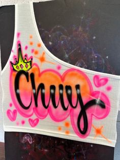 a crop top with the word crazy painted on it and a crown in the middle