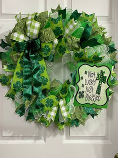 a st patrick's day wreath on a door with the words not lucky, just blessing