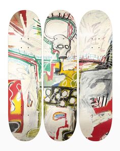 three skateboards with different designs on them, one is white and the other is red