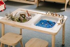 a child's table and chairs in a room with toys on the floor next to each other