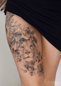 a woman's thigh with a lion and flowers on it